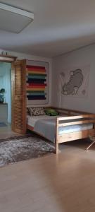 a bedroom with a bed with a wooden headboard at Another day in Jeju in Seogwipo