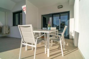 a white dining room table and chairs in a room at Apartment Laguna Azul in El Mojón