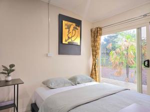 a bedroom with a bed and a window at Seaside Exotic Studio in Suva City Quality bedding free wifi n parking in Suva