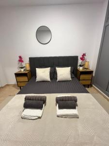 a bedroom with a large bed with three pillows at Magdalena Apartament in Torrevieja +8 photos