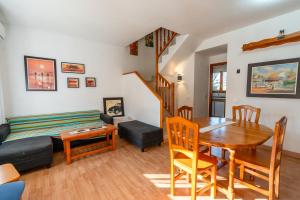a living room with a table and a couch at Beach House Roda de Bera in Roda de Bará