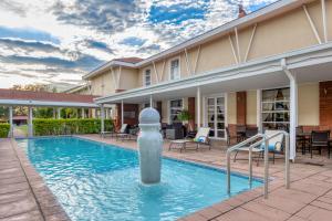 a pool with a water fountain in the middle of a building at Protea Hotel by Marriott Nelspruit in Nelspruit