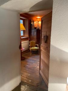 a hallway with a door and a chair in a room at Serre Chevalier , Saint Chaffrey Chalet in Saint-Chaffrey