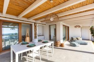 a living room with a white table and chairs at Villa LUNA in Oasi dei Due Mari