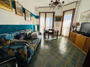 a living room with a couch and a tv at Suite Euforbia Bilo - Sanremo in Sanremo