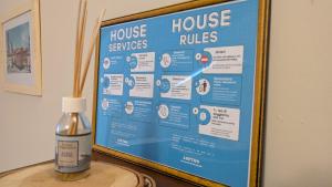 a sign with a bottle of house services services at Loft64 in Alba