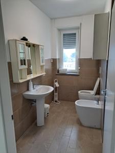 a bathroom with a sink and a tub and a toilet at Malnati home in Terni +48 photos