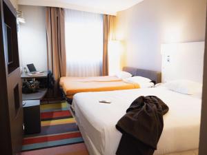 Postel nebo postele na pokoji v ubytování ibis Styles Lyon Sud Vienne