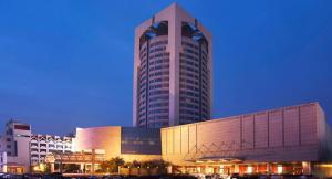 a large building with a large tower in front of it at Xian heng Hotel in Shaoxing