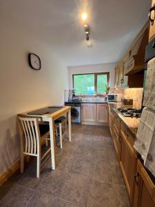 a kitchen with a table and a counter top at Mourne Coastal Guesthouse in Newcastle