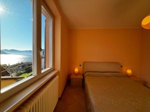 Postel nebo postele na pokoji v ubytování La casa di Emy- Larihome A74