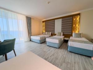 Postel nebo postele na pokoji v ubytování Concordia Celes Beach Hotel