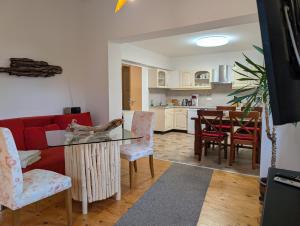 a living room with a red couch and a table at Fewo Cosel Castello mit Sauna in Stolpen
