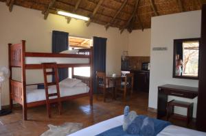 a bedroom with a bunk bed and a kitchen with a table at Tava Lingwe Game Lodge & Wedding Venue in Parys +103 photos