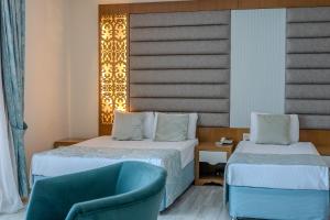 Postel nebo postele na pokoji v ubytování Concordia Celes Beach Hotel