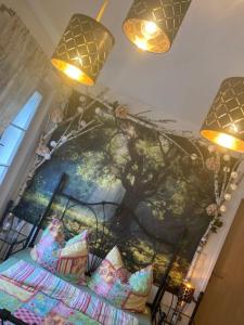 a bedroom with a painting of a tree on the wall at Katharina Haus, Wiel in Wiel