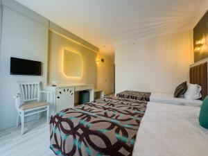 Postel nebo postele na pokoji v ubytování Concordia Celes Beach Hotel