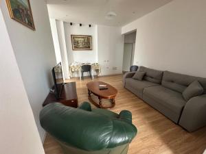 a living room with a couch and a table at Tulip Apartment - Amazing Central Location in Tirana
