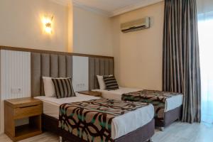 Postel nebo postele na pokoji v ubytování Concordia Celes Beach Hotel