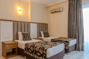 Postel nebo postele na pokoji v ubytování Concordia Celes Beach Hotel