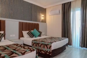 Postel nebo postele na pokoji v ubytování Concordia Celes Beach Hotel