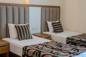 Postel nebo postele na pokoji v ubytování Concordia Celes Beach Hotel