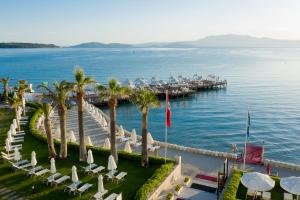 an aerial view of a marina with chairs and palm trees at Boyalik Beach Hotel & Spa Cesme in Çeşme