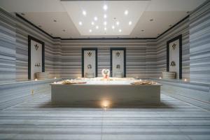 a large room with a bathtub in the middle of it at Boyalik Beach Hotel & Spa Cesme in Çeşme