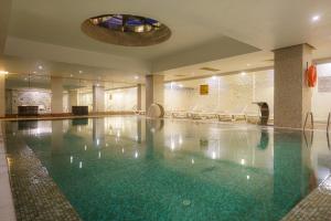 a large swimming pool in a hotel room at Boyalik Beach Hotel & Spa Cesme in Çeşme