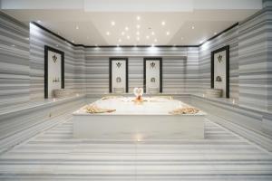 a rendering of a room with a bath tub at Boyalik Beach Hotel & Spa Cesme in Çeşme