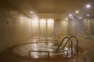an empty room with a pool of water in a gym at Boyalik Beach Hotel & Spa Cesme in Çeşme