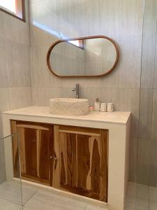 a bathroom with a sink and a mirror at Central house with 2 large bedrooms in Kuta Lombok