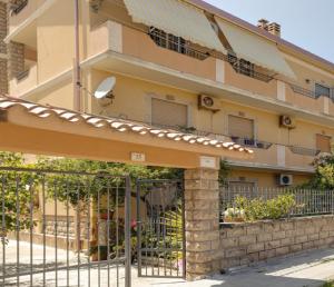 a building with a gate in front of it at Appartamento casa vostra in Bosa