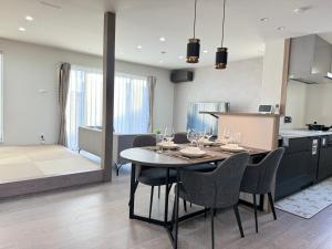 a kitchen and dining room with a table and chairs at Akikawa Miyoshi 4 in Fukumoto +24 photos