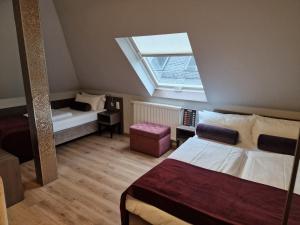 a small room with two beds and a window at Arena Villa am Wasserpark in Frankfurt/Main +32 photos