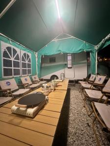 a group of chairs and tables in a tent at The Starry Campervans Cameron Highlands in Cameron Highlands +21 photos