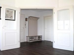 an empty room with white walls and two doors at Dorow Ferienwohnung in Redewisch