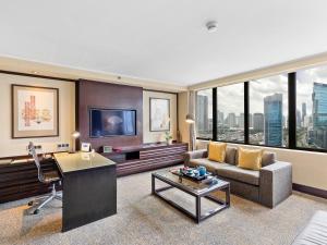 a living room with a couch and a table at Mandarin Oriental, Jakarta in Jakarta