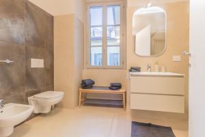a bathroom with a toilet and a sink and a mirror at Casa Lenora in Bellano +41 photos