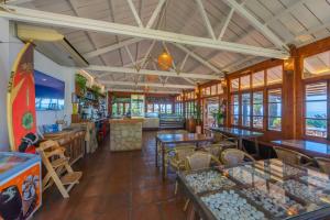 a restaurant with tables and chairs and a counter at Hurricane Beach Hotel in Tarifa