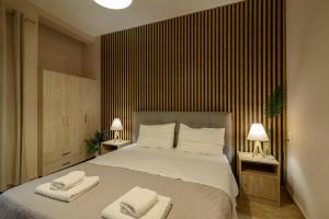 a bedroom with a bed with two towels on it at Melina's Studios in Argalasti