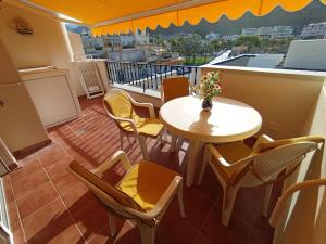 a room with a table and chairs and a balcony at Playa de Mogn Alysio 8 in Puerto de Mogán