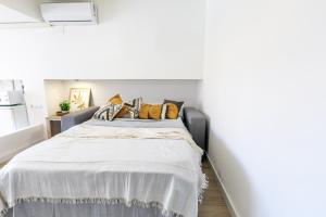 a bedroom with a large bed with yellow pillows at Mediterranean Way - Promar 248 in La Pineda