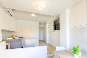 a white apartment with a bedroom and a bed at Mediterranean Way - Promar 248 in La Pineda
