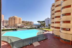 a swimming pool in a building next to a building at Mediterranean Way - Promar 248 in La Pineda