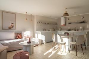 a living room with a couch and a table and chairs at RentPlanet - Apartamenty Rynek in Wrocław