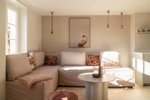 a living room with a couch and a table at RentPlanet - Apartamenty Rynek in Wrocław