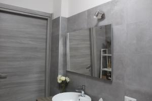 a bathroom with a sink and a mirror at Sveva Haven Malpensa in Case Nuove +20 photos