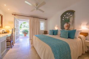 a bedroom with a large bed with blue pillows at Hurricane Beach Hotel in Tarifa