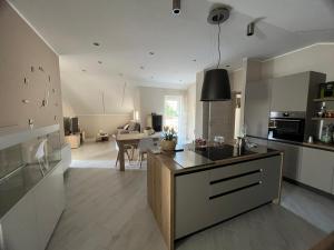 a kitchen and living room with a sink and a counter at La Dimora del Casaro in Castrovillari